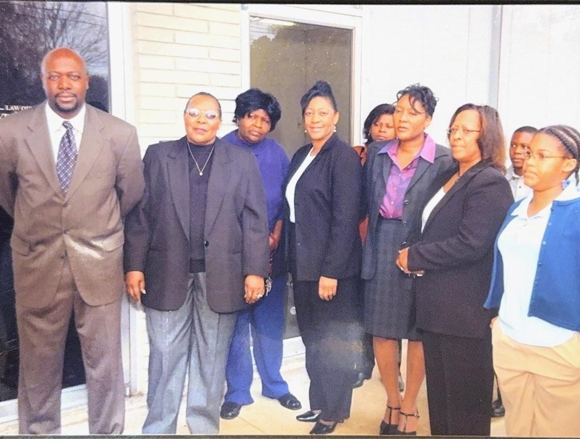 Cloyd Benjamin with community members outside a public building