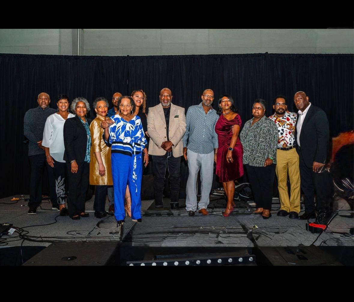 Cloyd Benjamin with family on stage at the Next Chapter Celebration