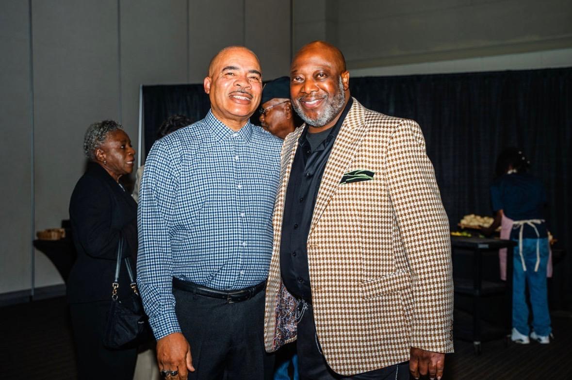 Cloyd Benjamin with a community leader at a public gathering