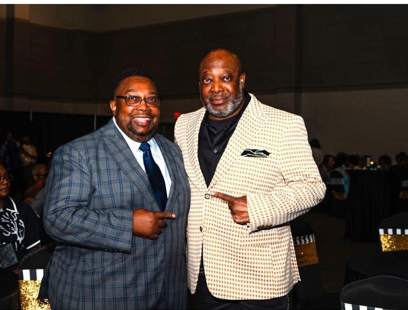 Cloyd Benjamin with a community member at a public gathering