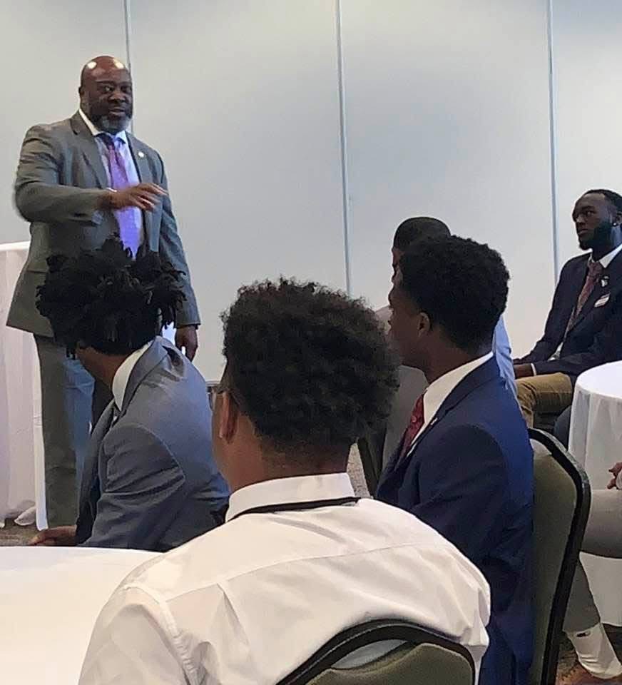 Cloyd Benjamin mentoring young men at a community event